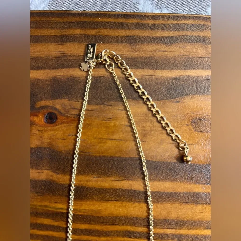 Kate Spade Pink and Gold Bow Necklace gold tone with pink enamel bow feminine